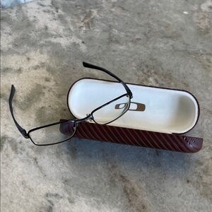 Oakley black/grey metal frames. Includes hard carrying case and cloth bag.
